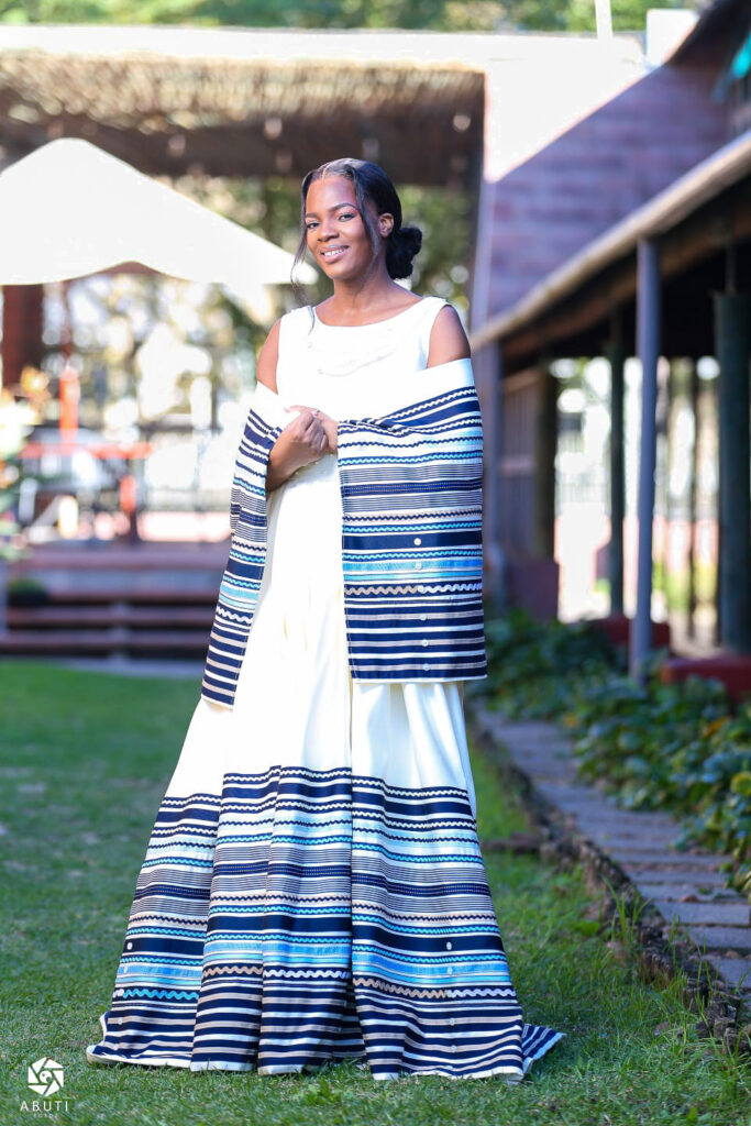 Full-length front view of the Traditional Xhosa Wedding Dress with striped ribbon detailing and matching wrap