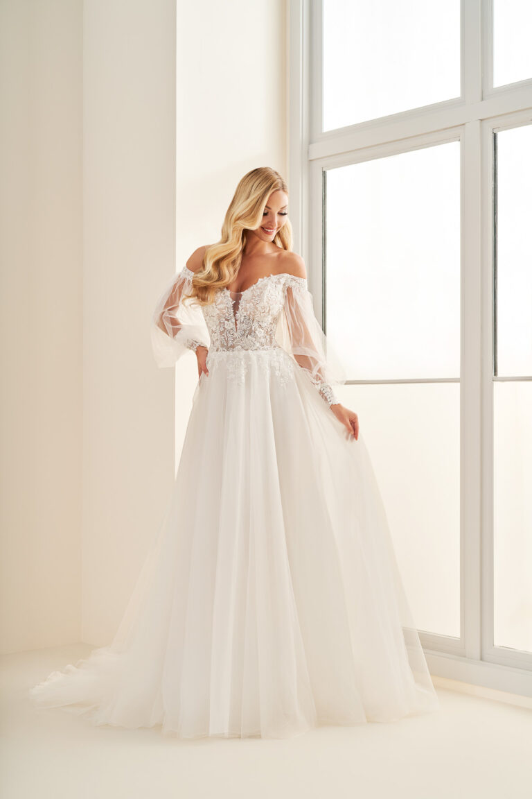 Full-length front view of the E512 ivory A-line bridal gown with off-the-shoulder lace bodice and flowing skirt