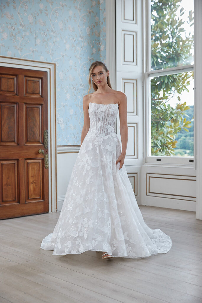 Full-length front view of the Minerva ivory ball gown with strapless lace bodice and full skirt
