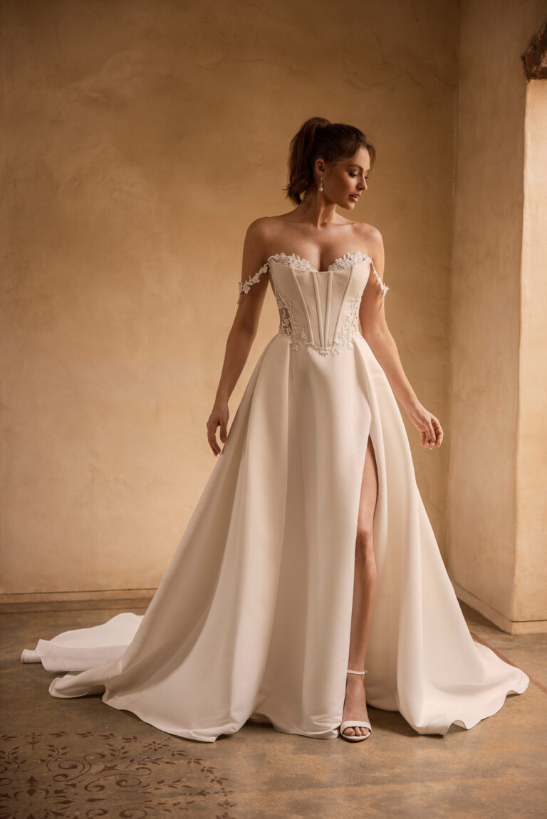 Full-length front view of the Rue Y3171 ivory ball gown with corset bodice and slit skirt