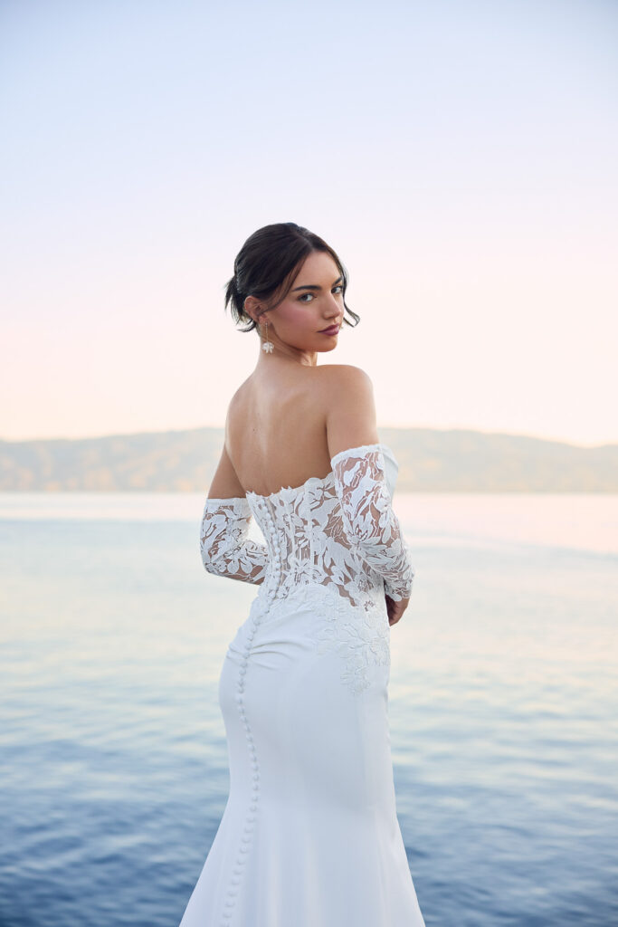 Close rear view of the Lucie bridal gown showing the lace-up back and off-the-shoulder sleeves
