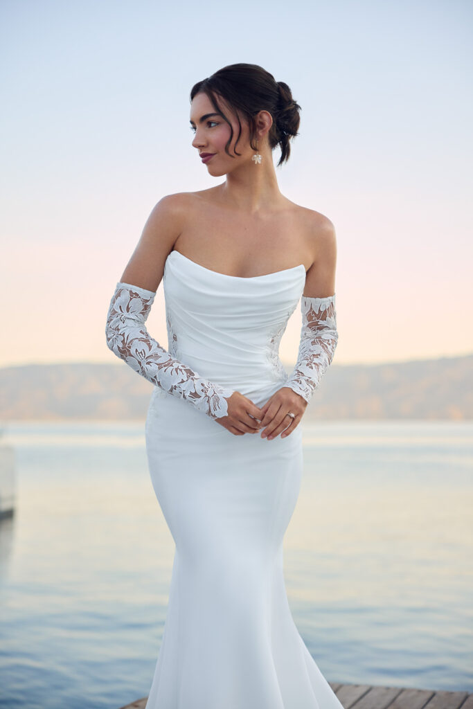 Front view of the Lucie bridal gown showing the draped neckline and long floral lace sleeves